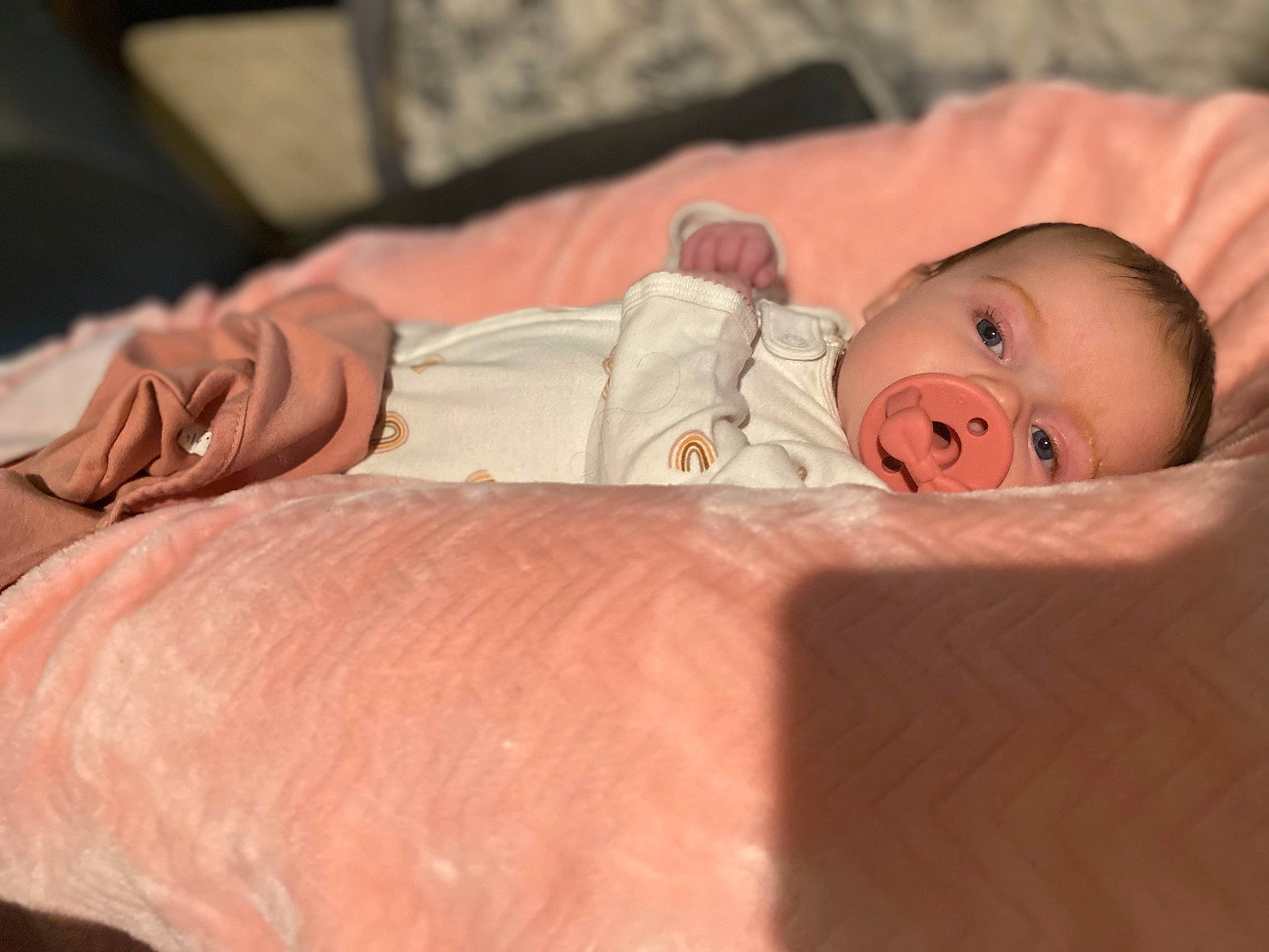 Aspen is registered to the contest to win money with this photo: baby, baby_products, baby_toddler_clothing, bedding, bedtime, cheek, child, chin, comfort, eye, hand, head, headgear, human_body, linens, mouth, person, pink, skin, toddler