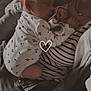 Kimberly Le Moal a rejoint le concours — aidez-le/la à gagner de superbes lots ! baby, woman, sleeping, holding, cherry_pattern, onesie, striped_clothing, necklace, heart_shaped, pacifier, couch, indoor, closeup, portrait, comfort, affection, soft_lighting, warm_tones, casual_clothing, relaxation