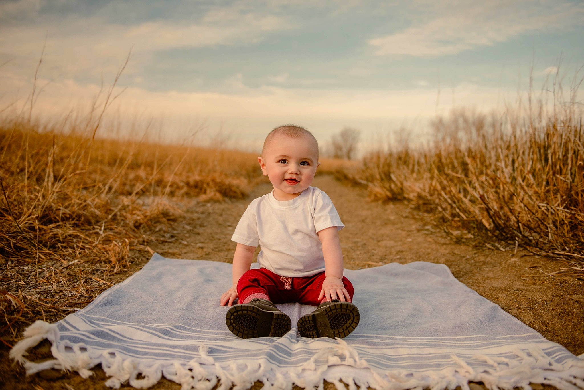 Milo is registered to the contest to win money with this photo: baby_toddler_clothing, child, cloud, ecoregion, flash_photography, fun, grass, grass_family, grassland, happy, joy, landscape, leisure, people_in_nature, person, plant, sky, sleeve, smile, t_shirt
