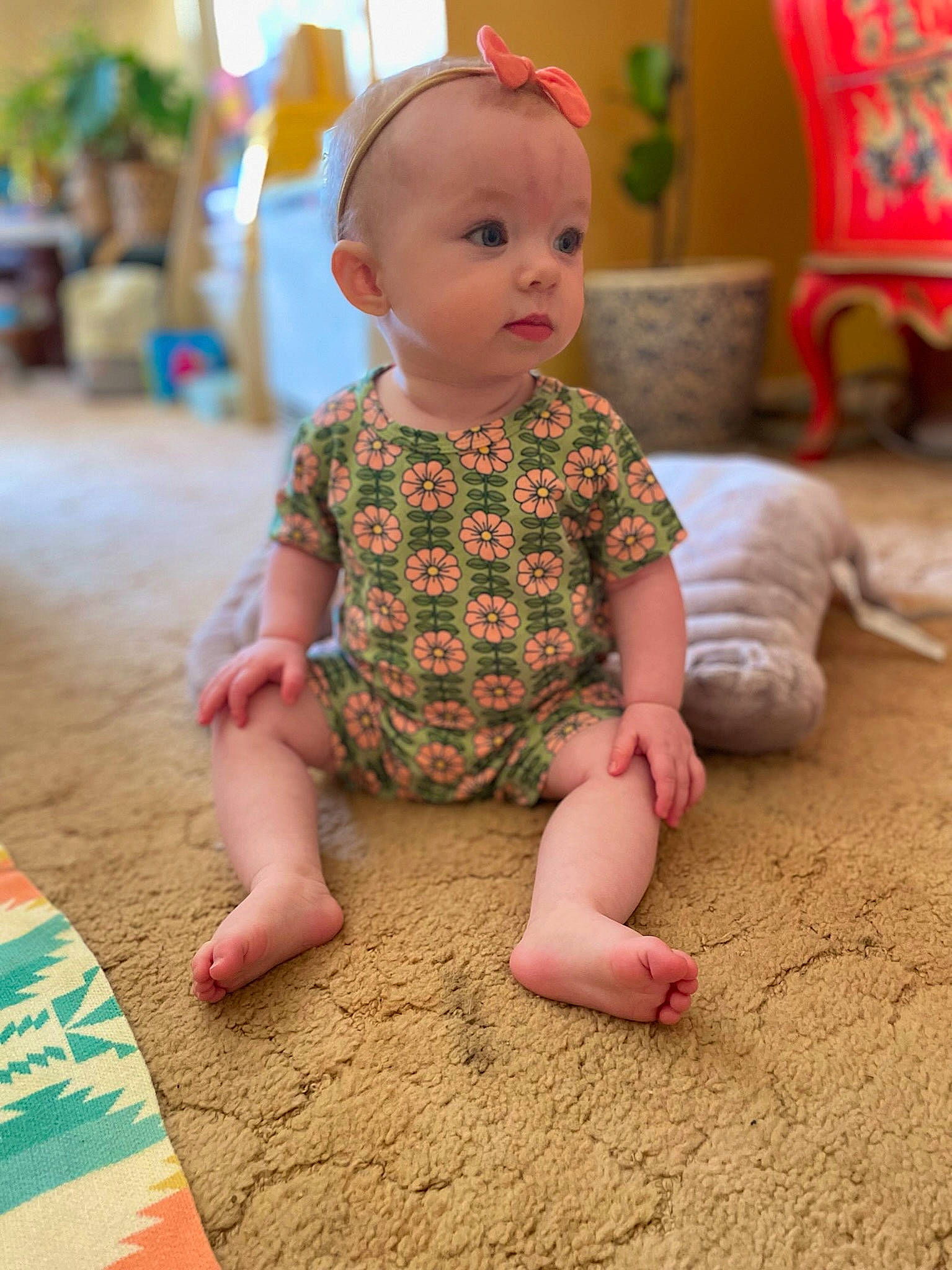 Ellis joined the competition — help win amazing prizes! baby, baby_toddler_clothing, barefoot, cheek, child, finger, floor, flooring, foot, fun, happy, hardwood, houseplant, human_leg, person, plant, sitting, skin, sleeve, toddler