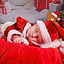 baby, sleeping, santa_hat, christmas, holiday, red_clothing, blanket, teddy_bear, gift_box, christmas_tree, decorations, festive, soft_texture, cute, portrait, indoor, holiday_season, infant, cozy, sleep