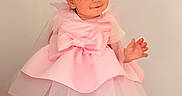 Dahlia Mila joined the competition — help win amazing prizes! toddler, child, pink_dress, bow, barefoot, smile, standing, cute, indoors, soft_light, portrait, young_child, fashion, playful, short_hair, white_background, happy, person, full_body, innocence