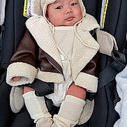Sophia joined the competition — help win amazing prizes! baby, child, car_seat, jacket, knit_hat, shearling, warm_clothing, cute, infant, face, legs, socks, seatbelt, adorable, expression, indoor, person, fashion, cozy, portrait