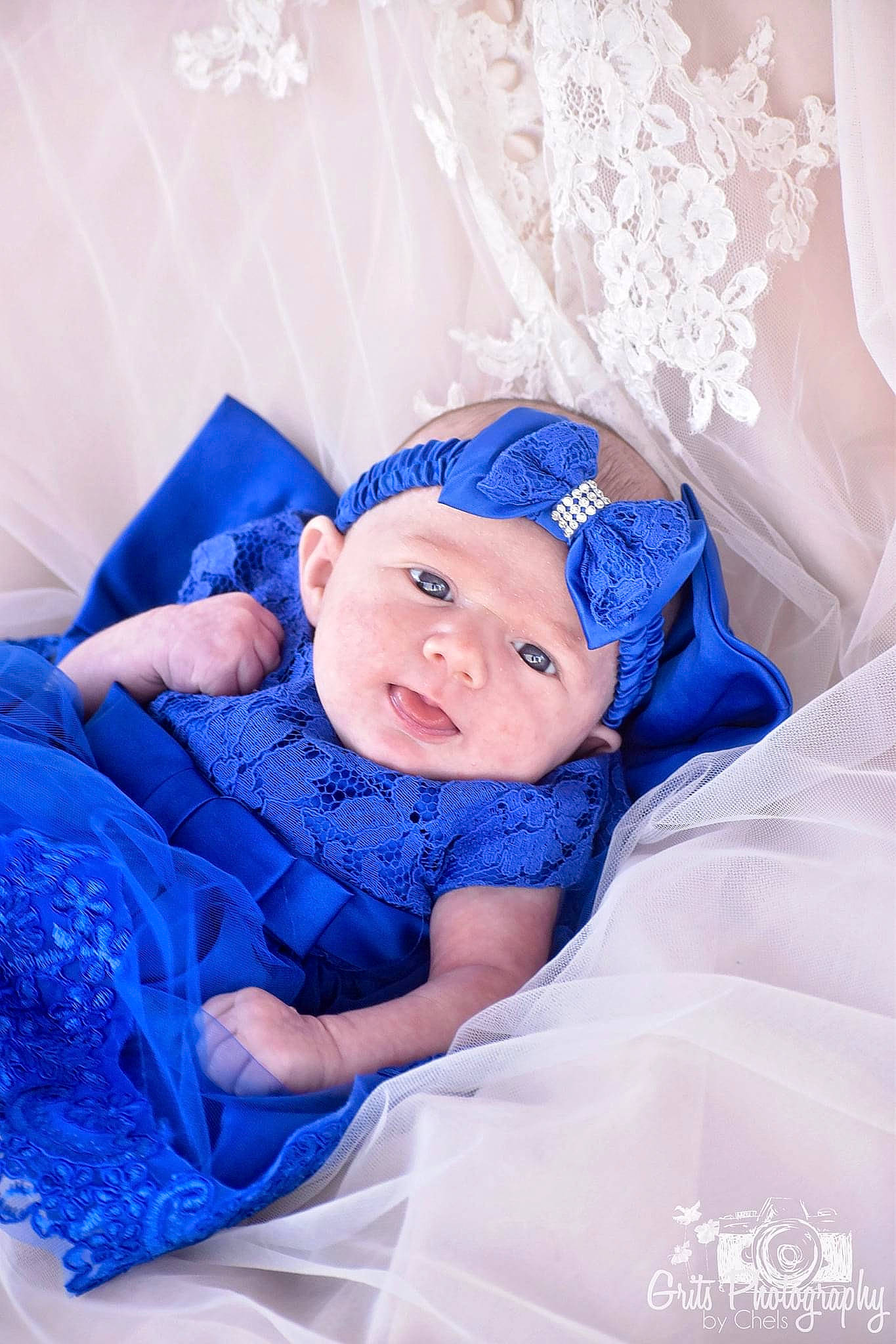Addilyn is registered to the contest to win money with this photo: aqua, baby, baby_sleeping, baby_toddler_clothing, child, comfort, electric_blue, event, fashion_accessory, fun, hair_accessory, happy, hat, headpiece, headwear, linens, magenta, person, purple, smile