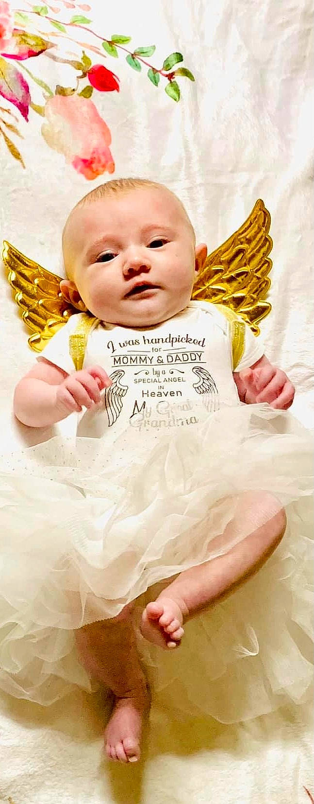 Addilyn is registered to the contest to win money with this photo: baby, baby_toddler_clothing, child, comfort, fashion_accessory, finger, fun, fur, gesture, happy, linens, outerwear, person, photograph, pink, sitting, skin, sleeve, textile, thumb