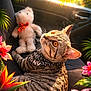 cat, tabby_cat, teddy_bear, plush_toy, car_seat, car_interior, bandana, whiskers, golden_eyes, sunlight, backlight, tropical_leaves, pink_flower, orange_flower, floral_frame, cozy, portrait, pet_accessory, foliage, summer_vibe