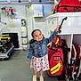 ambulance, child, cute, denim_jacket, dress, emergency, floor, girl, handle, happy, indoor, medical_equipment, oxygen_tank, pigtails, red_bag, shoes, smile, standing, white_cabinet, young_child