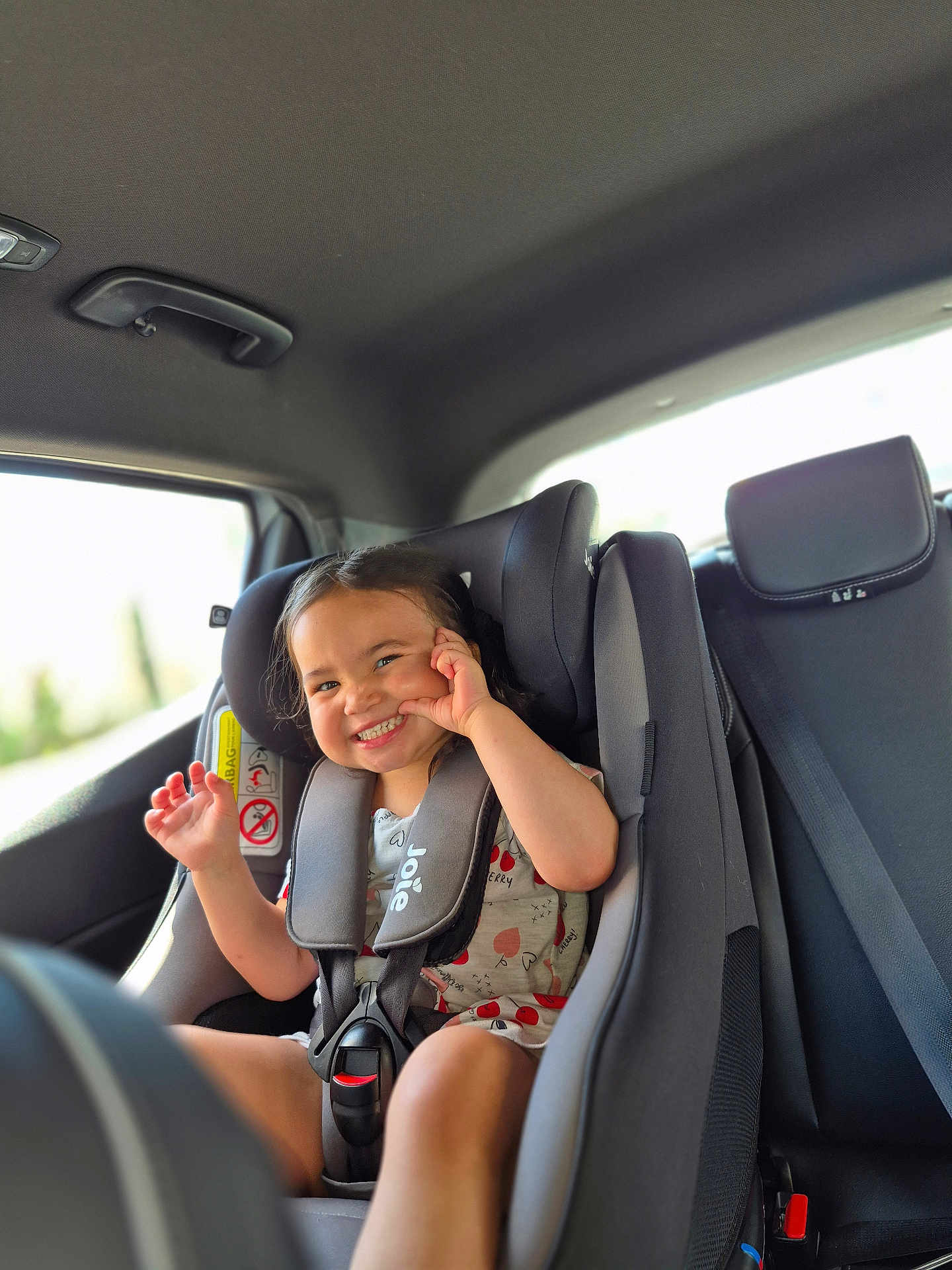 Elianah participe au concours pour gagner de l'argent avec cette photo : car_interior, car_seat, child, clothing, cute, daylight, face, hair, happy, interior, joyful, person, playful, safety, seat, seatbelt, smile, toddler, vehicle, window