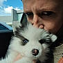 Everest a rejoint le concours — aidez-le/la à gagner de superbes lots ! black_and_white, blue_eyes, building, car_interior, close_up, clouds, coat, dog, eyebrows, face, fluffy, fur, hand, kiss, nose, person, portrait, puppy, sky, window