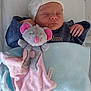 newborn, baby, sleeping, hat, blanket, stuffed_toy, mouse, soft_toy, crib, clothing, hand, face, infant, cozy, bed, child, cute, resting, indoor, peaceful