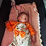 Andréa a rejoint le concours — aidez-le/la à gagner de superbes lots ! newborn, baby, sleeping, orange_clothing, elephant_print, pink_blanket, crocheted_blanket, bassinet, infant, cute, peaceful, child, portrait, indoors, soft_texture, cozy, small_hand, head, sleep, resting