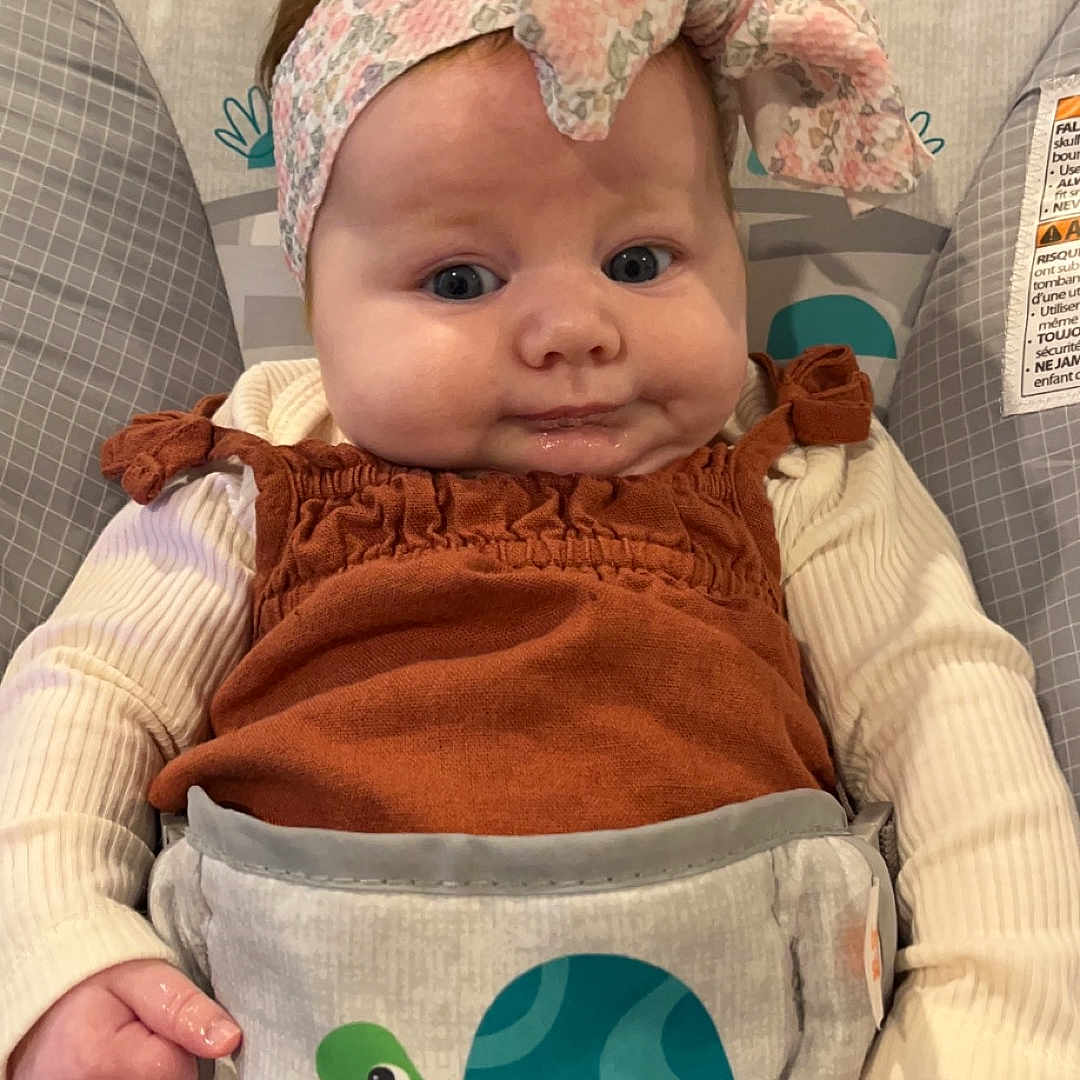 Runa Quinn is registered to the contest to win money with this photo: accessories, applique, architecture, baby, baseballcap, bed, blanket, bodypart, bonnet, building, cap, car, car_interior, carseat, chair, clothing, coat, costume, couch, crib