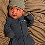 Genesis joined the competition — help win amazing prizes! baby, infant, onesie, beanie, clothing, blanket, bed, indoor, person, cute, child, face, headwear, small, lying_down, looking_away, soft_texture, blue, grey, cozy