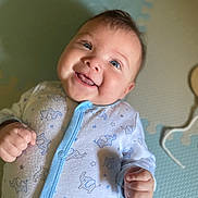 Genesis joined the competition — help win amazing prizes! baby, infant, smiling, blue_eyes, onesie, elephant_pattern, fists, play_mat, soft_surface, happy, cute, child, indoor, portrait, closeup, skin, face, head, expression, newborn