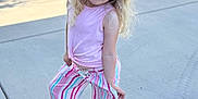 Paizley joined the competition — help win amazing prizes! child, girl, hat, sunhat, blonde_hair, curly_hair, pink_shirt, striped_pants, brown_shoes, sidewalk, outdoor, nature, greenery, playful_pose, sunlight, casual_clothing, cute, happy, young, portrait