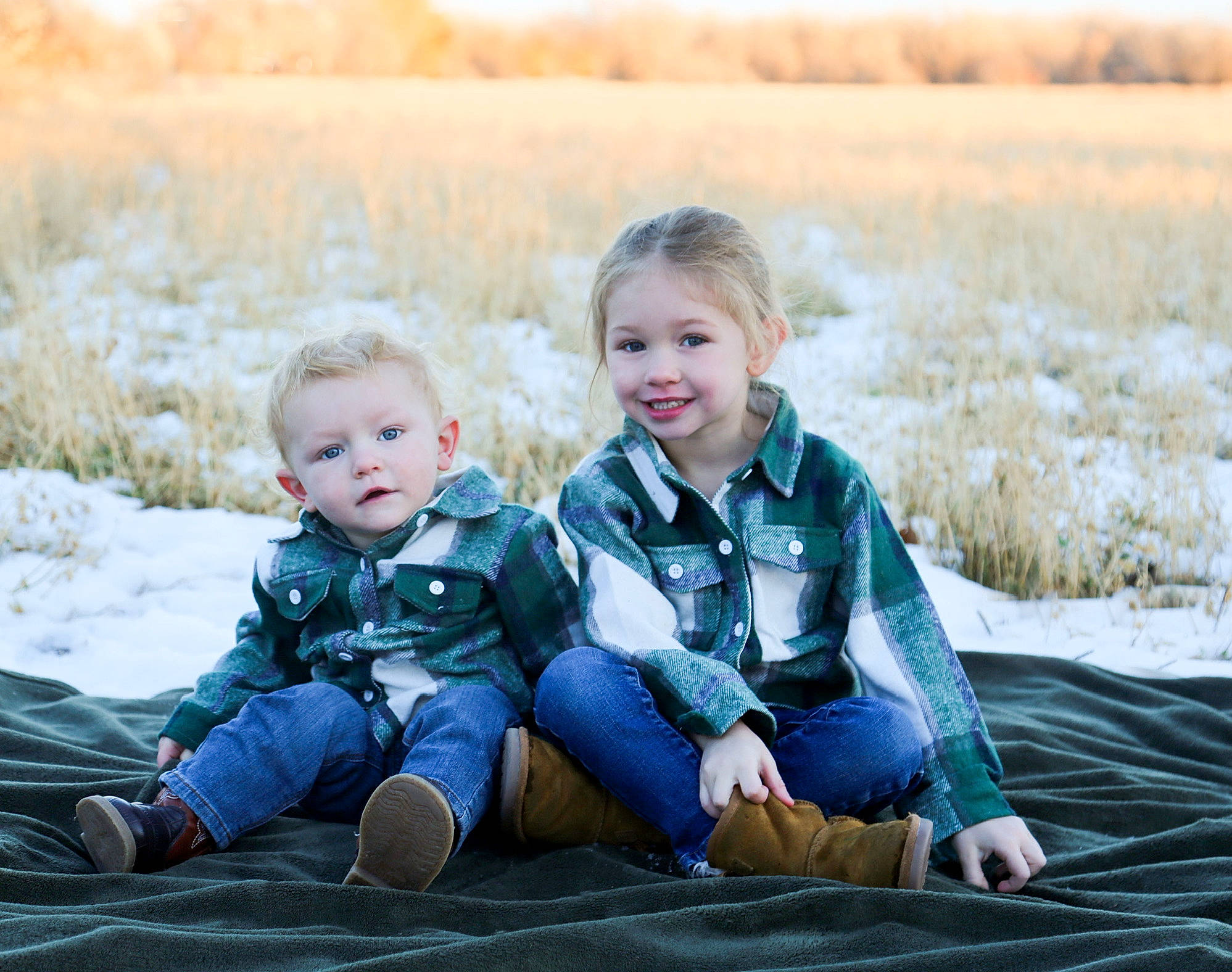 Charles is registered to the contest to win money with this photo: baby, child, face, flash_photography, fun, grass, grassland, happy, joy, landscape, leisure, morning, natural_landscape, people, people_in_nature, person, photograph, sitting, sky, smile