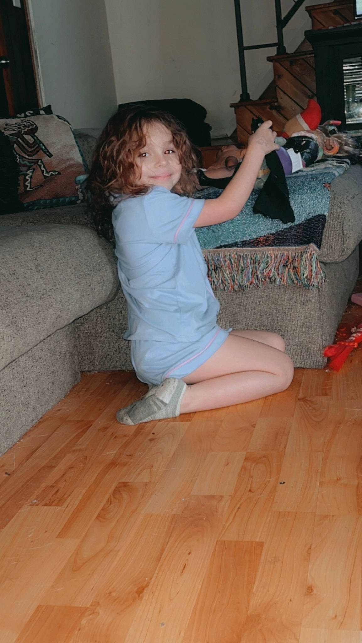 Kelani joined the competition — help win amazing prizes! arm, comfort, couch, finger, floor, flooring, foot, fun, hand, hardwood, human_body, human_leg, joy, knee, living_room, long_hair, person, smile, thigh, thumb