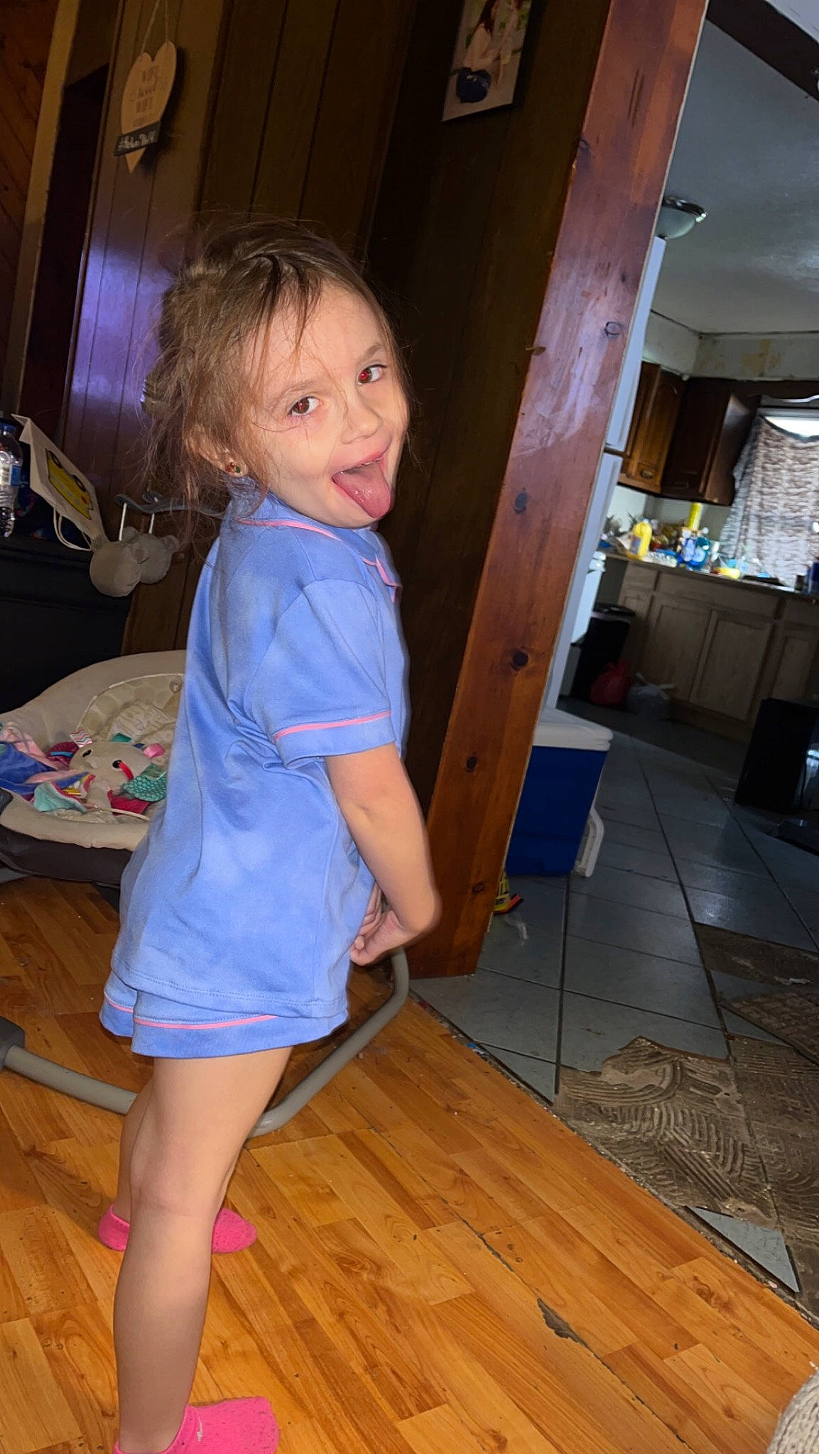 Kelani is registered to the contest to win money with this photo: blond, chair, electric_blue, floor, flooring, fun, hardwood, human_leg, joint, long_hair, person, purple, shoulder, smile, standing, thigh, trunk, varnish, waist, wood
