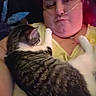 affection, blanket, cat, closeup, couch, cuddling, face, furry, home, indoor, oxygen_tube, person, pet, portrait, relaxed, selfie, sleeping, striped_fur, tabby_cat, yellow_shirt