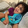 Hailee joined the competition — help win amazing prizes! toddler, child, smile, curly_hair, blanket, couch, pillow, indoor, happy, person, cozy, casual, home, relaxing, comfort, portrait, sitting, clothing, furniture, human