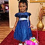 Sarai is registered to the contest to win money with this photo: child, girl, blue_dress, basket, easter, indoor, carpet, smile, hair_style, shoes, wooden_floor, decor, vase, picture_frame, wall, toy, happy, portrait, person, home