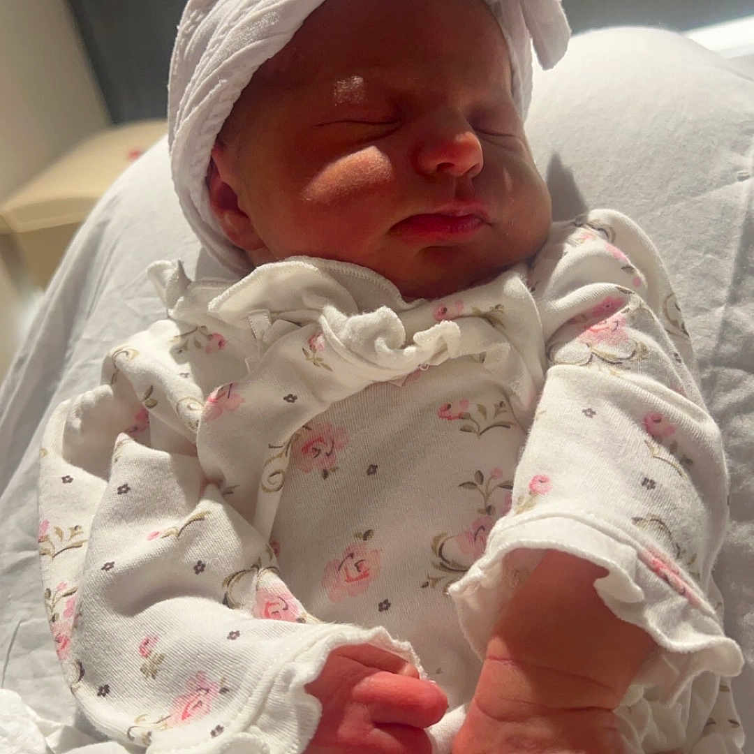 Josephine is registered to the contest to win money with this photo: architecture, baby, bed, blanket, bodypart, bonnet, building, clothing, face, furniture, glove, hat, head, hospital, newborn, person, photography, portrait, quilt, sleeping