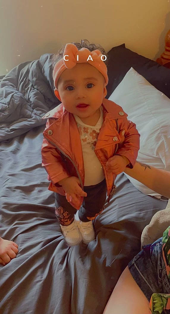 Kaliah joined the competition — help win amazing prizes! baby, baby_products, baby_toddler_clothing, child, comfort, couch, eye, fun, headgear, headwear, iris, lap, linens, mammal, person, personal_protective_equipment, pillow, pink, sitting, sleeve