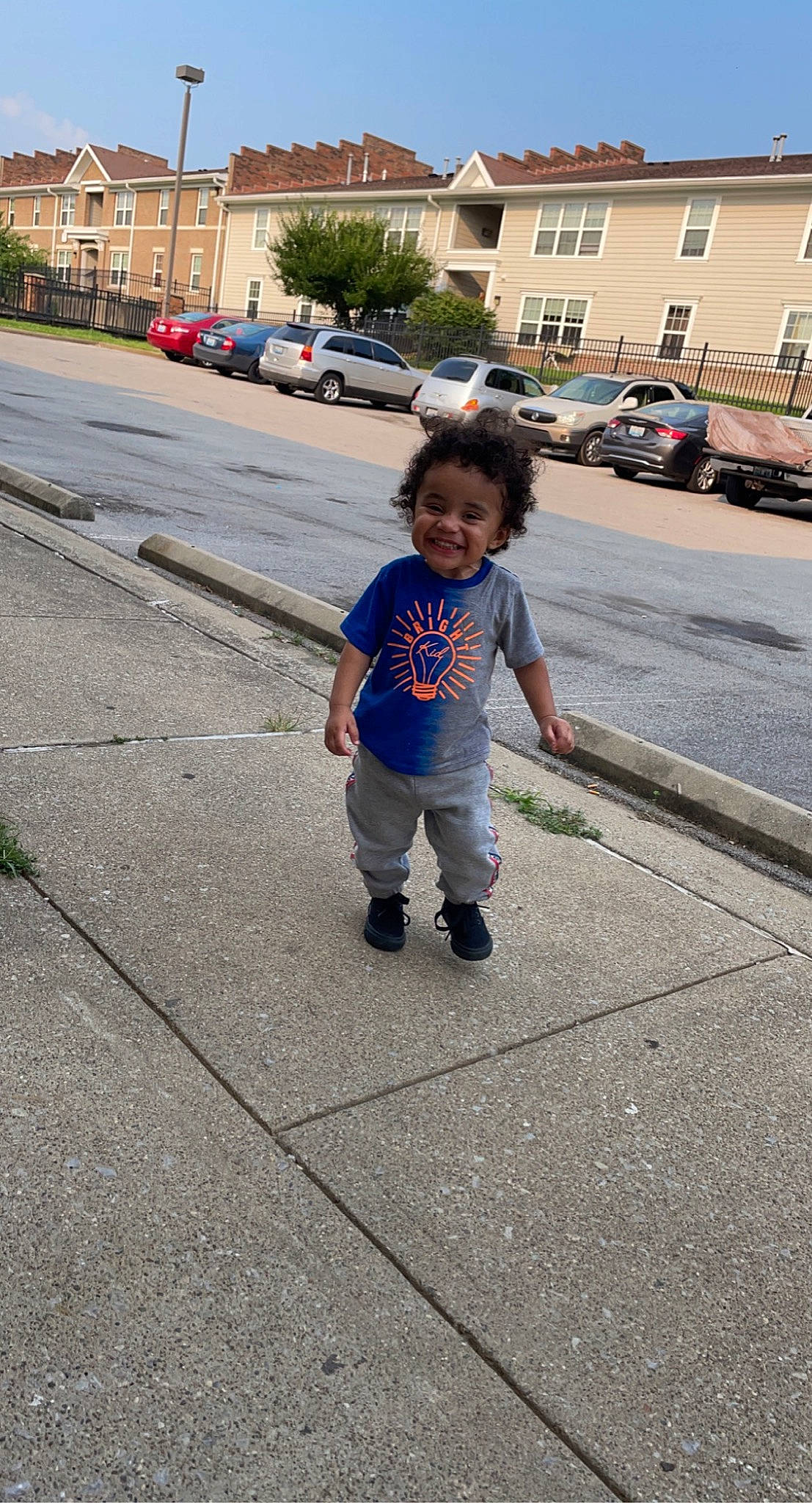 Major is registered to the contest to win money with this photo: asphalt, car, city, electric_blue, fun, joy, leisure, pedestrian, person, recreation, road, road_surface, sidewalk, sky, tar, tire, toddler, travel, tree, walking