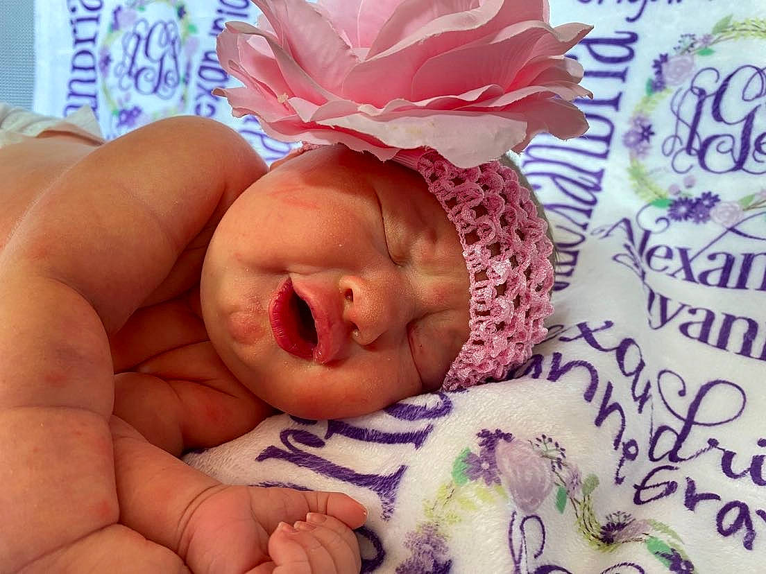 Alexandria joined the competition — help win amazing prizes! baby, baby_sleeping, baby_toddler_clothing, bedtime, cheek, child, comfort, eyelash, finger, happy, headpiece, headwear, linens, lip, nail, person, petal, pink, skin, textile