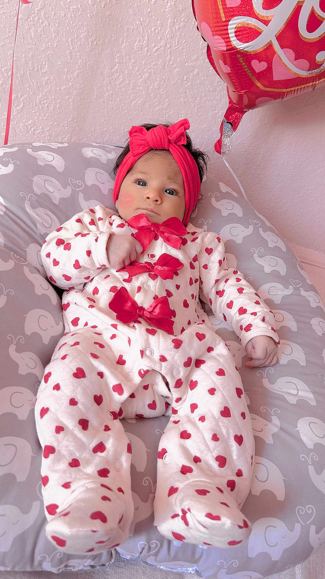 Antonella joined the competition — help win amazing prizes! baby, balloon, bow, cheeks, cute, dark_hair, elephant_print, feet, hand, headband, heart_pattern, indoor, infant, nursery, onesie, peaceful, pillow, pink, portrait, soft_light