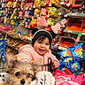Amira Sophia joined the competition — help win amazing prizes! toddler, child, dog, shopping_cart, blanket, snacks, candy, store_aisle, pink_jacket, headband, bunny_ears, happy, smiling, pet, retail, indoor, cute, small_dog, baby, shopping