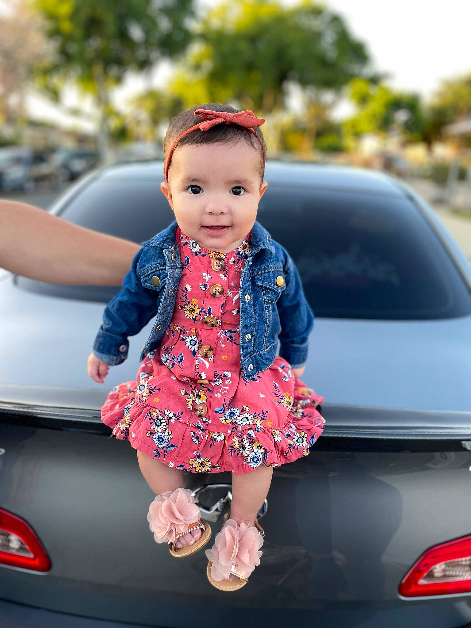 Mikayla is registered to the contest to win money with this photo: automotive_design, automotive_exterior, automotive_lighting, automotive_tail_brake_light, bumper, car, electric_blue, hand, hood, joy, motor_vehicle, person, personal_luxury_car, pink, red, tints_and_shades, toddler, trunk, vehicle, vehicle_door