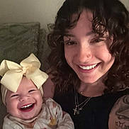 Eliyanah Jade joined the competition — help win amazing prizes! baby, bow, smile, woman, curly_hair, nose_ring, laughing, couch, blanket, tattoo, jewelry, necklace, indoor, person, happy, clothing, infant, family, portrait, cute