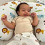 animal_print, baby, bear_pattern, bed, blanket, child, clothing, crocodile, cute, elephant, giraffe, happy, indoor, infant, lion, pillow, playful, portrait, smile, tiger