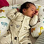 animal_print, baby, bed, blanket, cartoon_animals, child, crocodile, cute, elephant, giraffe, indoors, infant, lion, monkey, onesie, peaceful, pillow, rest, sleeping, soft