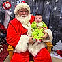 santa_claus, baby, child, christmas, holiday, festive, wreath, ornament, red_suit, white_beard, glasses, green_onesie, chair, indoor, decorations, smile, portrait, person, seasonal, celebration