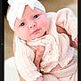 baby, baby_clothes, blue_eyes, bow, child, closeup, cute, expression, hand, headband, holding, indoor, infant, knitwear, newborn, person, pink_clothing, portrait, skin, soft_light