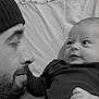 adult, baby, beanie, beard, bodypart, cap, clothing, couch, face, finger, furniture, hand, hat, head, male, man, newborn, person, photography, portrait