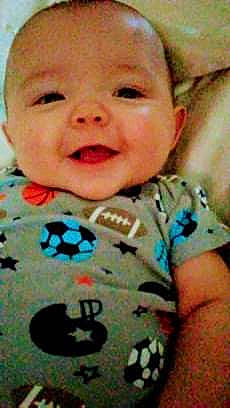 Eros is registered to the contest to win money with this photo: boy, cheek, child, chin, cool, eye, face, facial_expression, finger, forehead, hand, head, infant, lip, mouth, nose, person, skin, smile, toddler