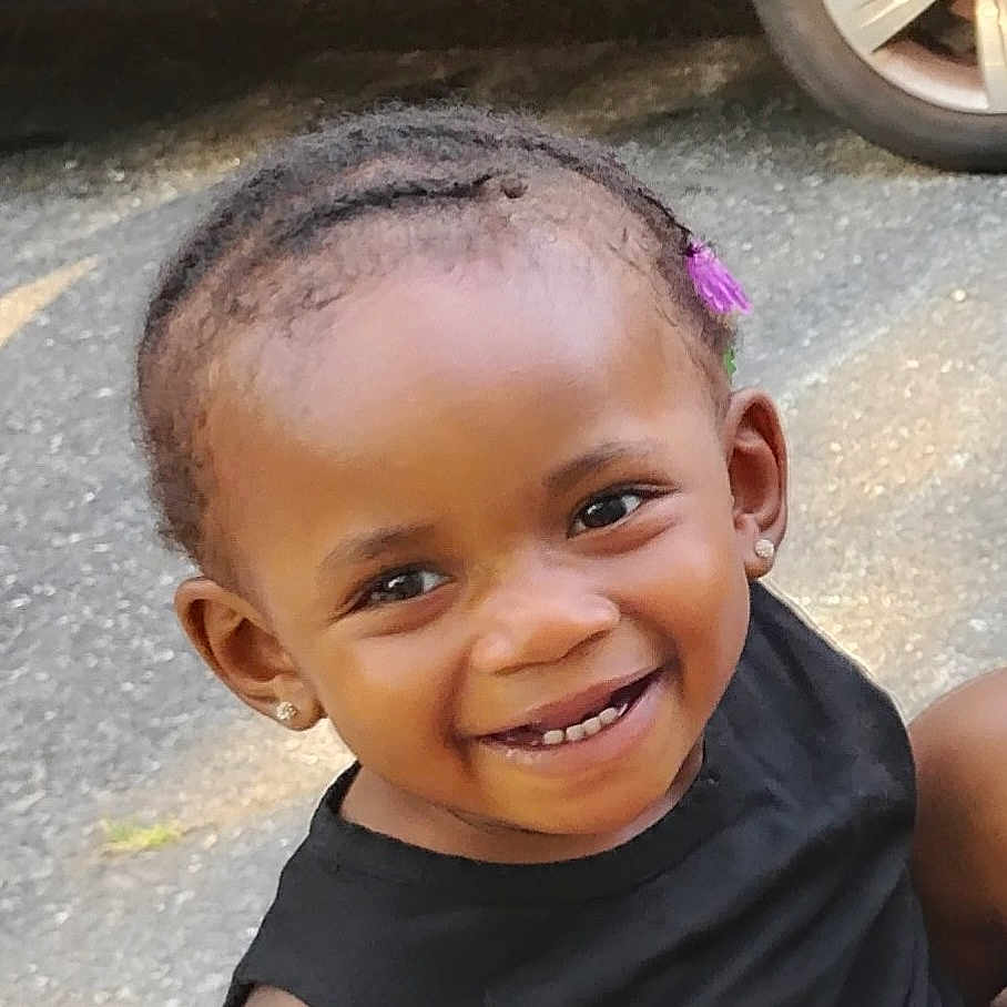 Julia is registered to the contest to win money with this photo: baby, babylaughing, blackhair, bodypart, child, cornrows, face, female, girl, hair, happy, head, machine, person, photography, portrait, shoulder, skin, smile, wheel
