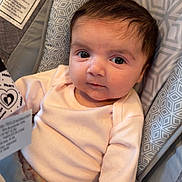 Francesca joined the competition — help win amazing prizes! baby, infant, face, big_eyes, looking_at_camera, pink_onesie, car_seat, bouncer, patterned_fabric, geometric_pattern, warning_label, short_hair, chubby_cheeks, small_hands, closeup, portrait, newborn, adorable, seat_pad, clothing_tag