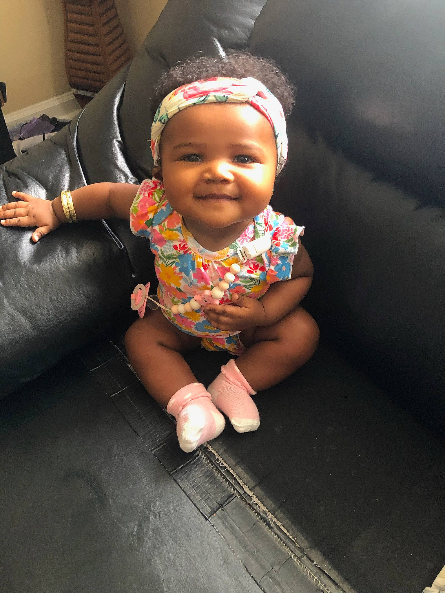 Alana Grace joined the competition — help win amazing prizes! baby, baby_toddler_clothing, cap, cheek, child, couch, face, flash_photography, floor, flooring, fun, happy, headgear, joy, lamp, person, sitting, skin, sleeve, smile