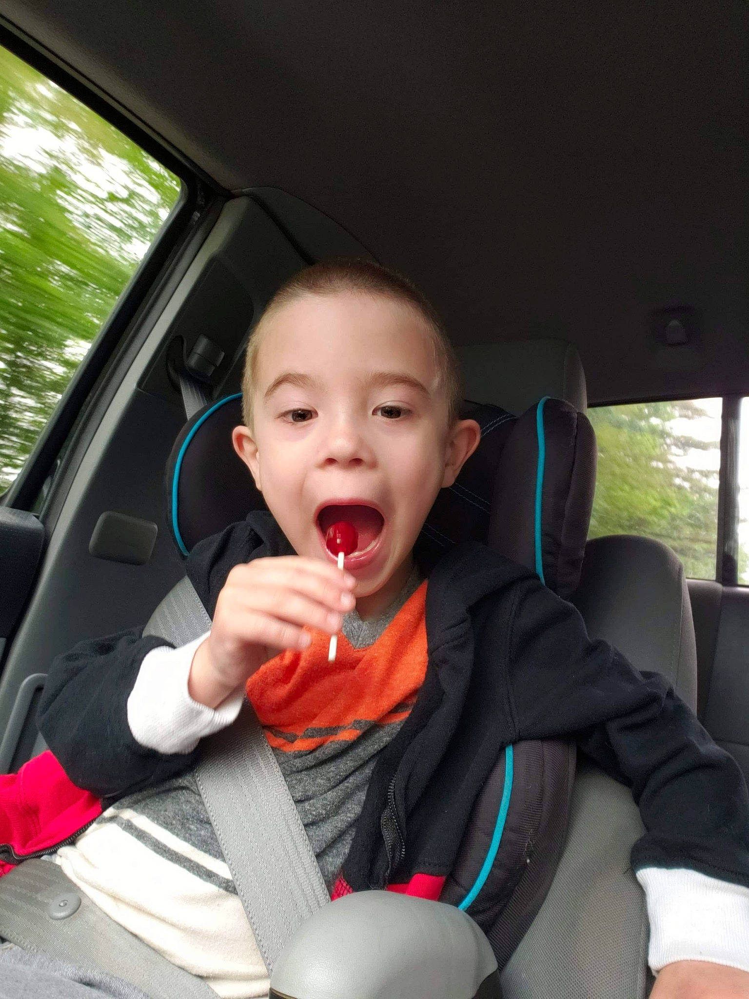Jensen joined the competition — help win amazing prizes! auto_part, baby, baby_in_car_seat, car, car_seat, child, driving, family_car, person, seat_belt, sitting, steering_wheel, surprise, toddler, vehicle