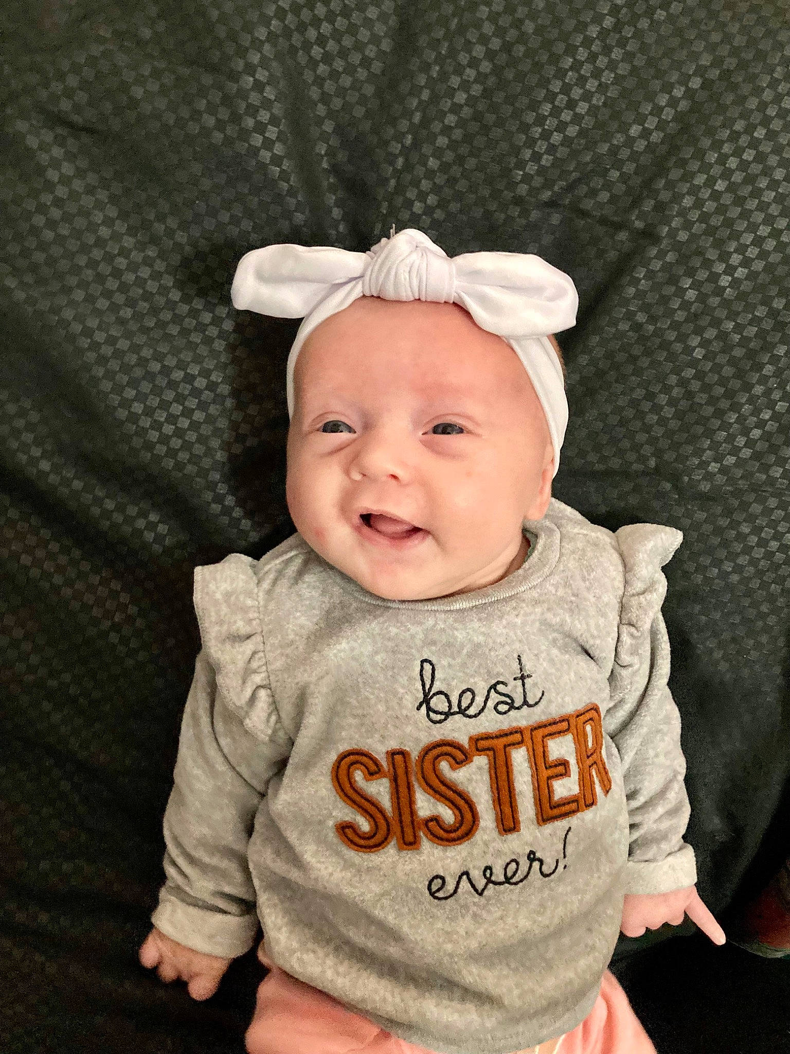 Willow is registered to the contest to win money with this photo: baby, baby_products, baby_toddler_clothing, cap, cheek, child, eye, face, fashion_accessory, happy, head, headgear, headpiece, neck, pattern, person, skin, sleeve, smile, t_shirt