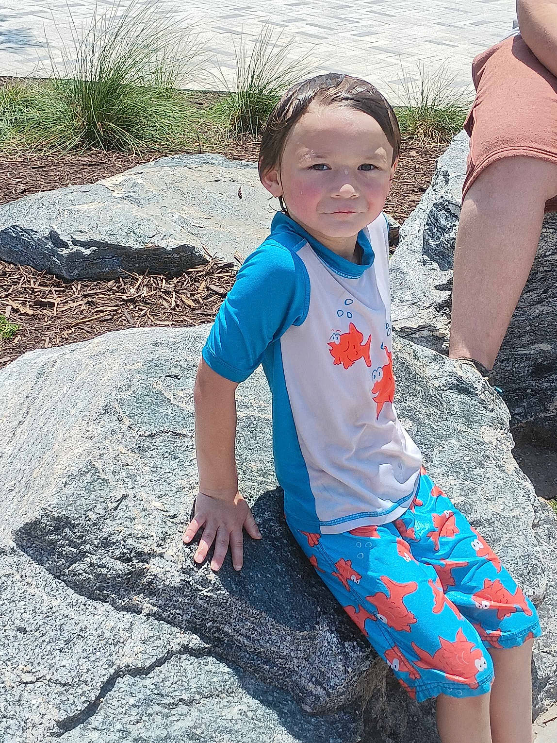 Easton joined the competition — help win amazing prizes! adaptation, body_of_water, child, electric_blue, fun, grass, happy, human_leg, leisure, people_in_nature, person, play, recreation, rock, sand, sitting, soil, t_shirt, thigh, toddler