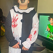 Evann a rejoint le concours — aidez-le/la à gagner de superbes lots ! animation, black_and_white, child, clown, costume, curtain, face_paint, floor, furniture, hair, hand, indoor, person, portrait, red_handprints, room, standing, television, toy_knife, young