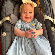 Mia participe au concours pour gagner de l'argent avec cette photo : baby, child, smiling, headband, dress, car_seat, seatbelt, infant, happy, cute, clothing, indoor, portrait, person, baby_girl, accessory, fabric, sitting, baby_clothes, light