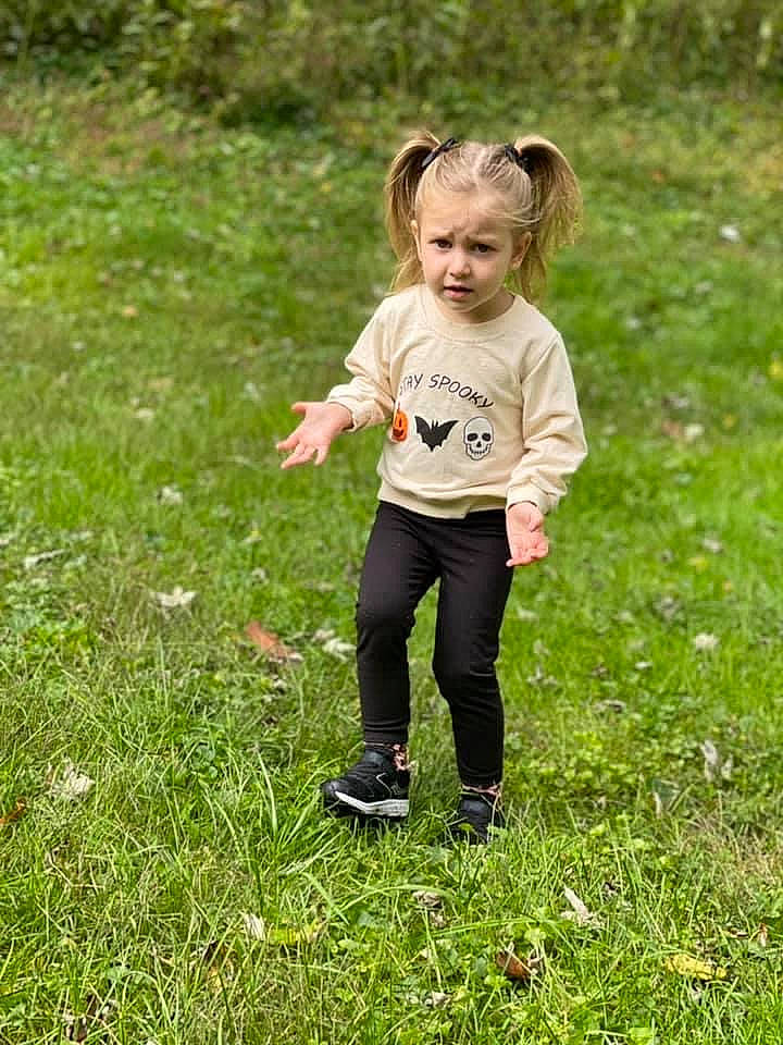 Emberlyn is registered to the contest to win money with this photo: child, fun, gesture, grass, grass_family, grassland, groundcover, happy, leisure, meadow, pasture, people_in_nature, person, plant, prairie, recreation, smile, soil, toddler, tree