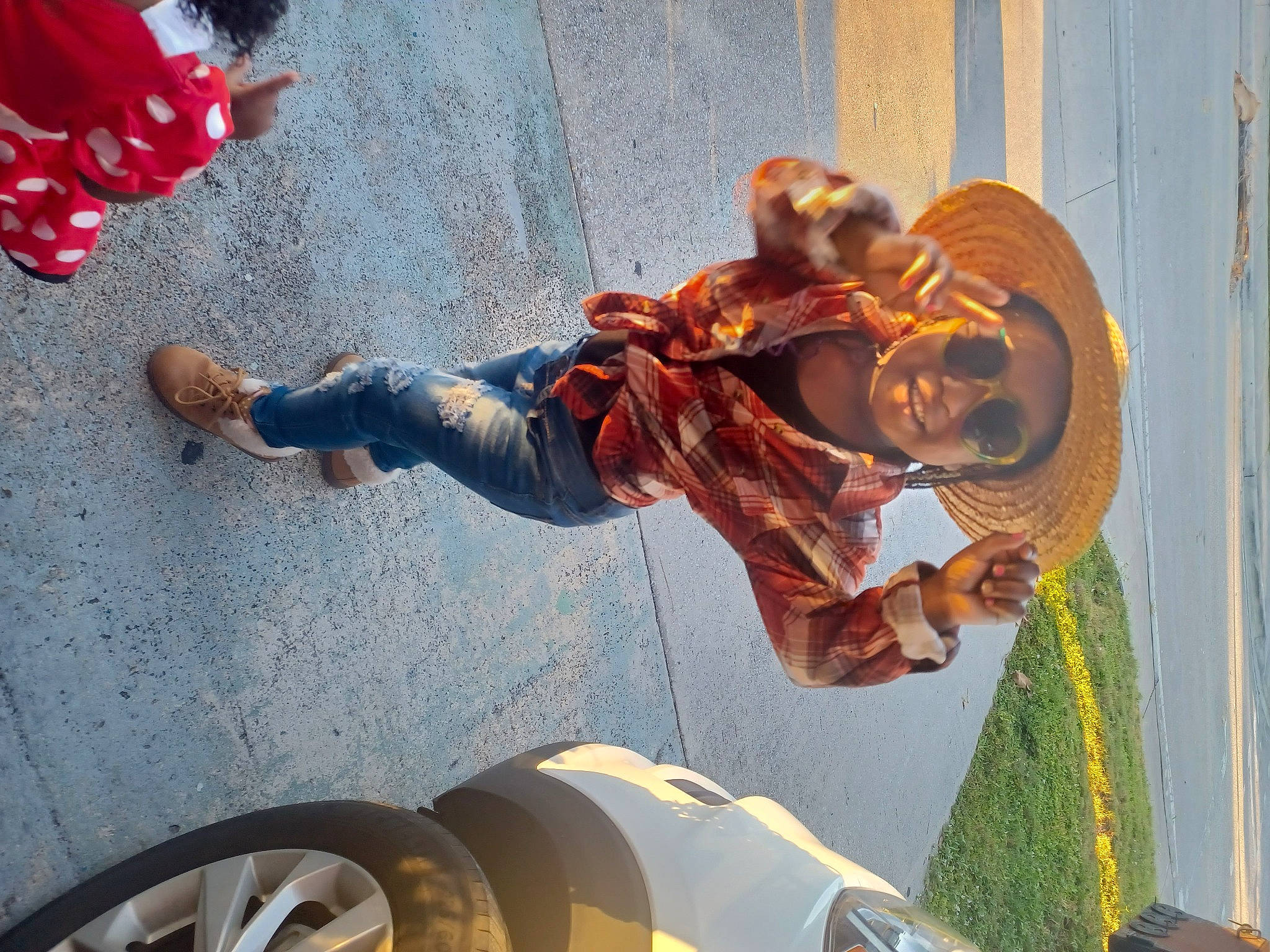 Kai is registered to the contest to win money with this photo: art, asphalt, automotive_tire, automotive_wheel_system, carmine, foot, fun, hat, headwear, human_leg, leisure, light, metal, person, photograph, sandal, sculpture, smile, statue