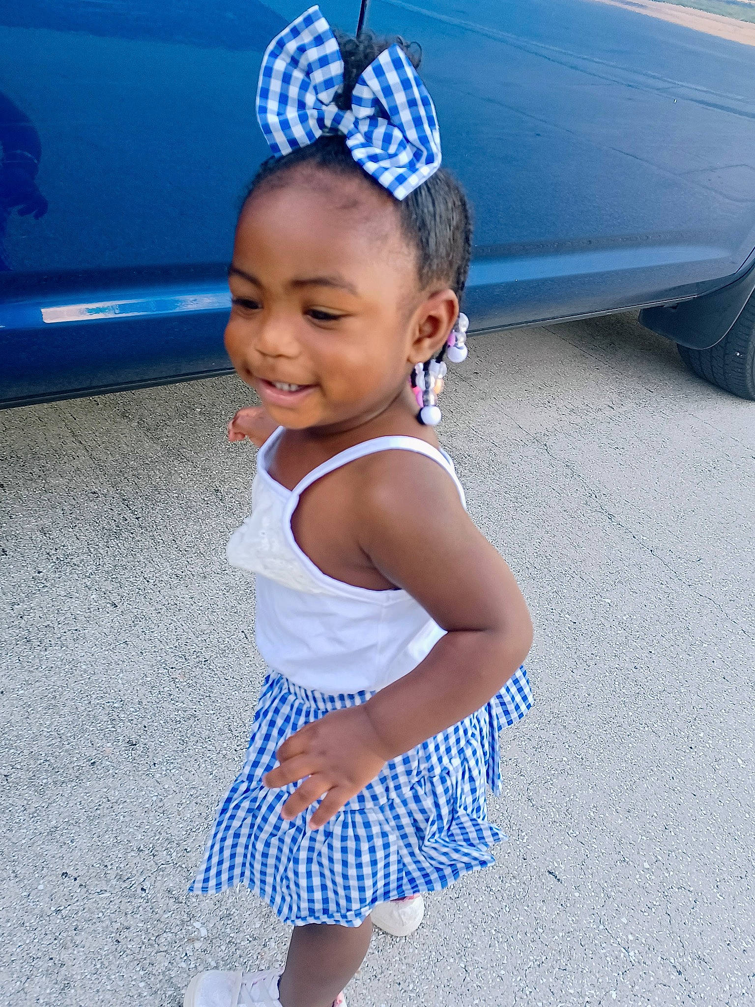 Kenzie is registered to the contest to win money with this photo: aqua, asphalt, automotive_exterior, automotive_tire, azure, baby_toddler_clothing, blue, child, electric_blue, fun, happy, hat, human_leg, joy, leisure, person, smile, tire, toddler, vehicle